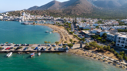 Fototapeta na wymiar panoramic view of the sea bay with boats and ancient buildings on the island of Crete filmed from a drone