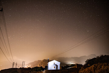landscape with a white church in the foreground against the background of a starry sky