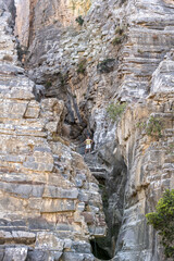 middle aged woman travels around the island of Crete and poses in beautiful places