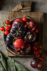 green and red tomatoes on a wooden board