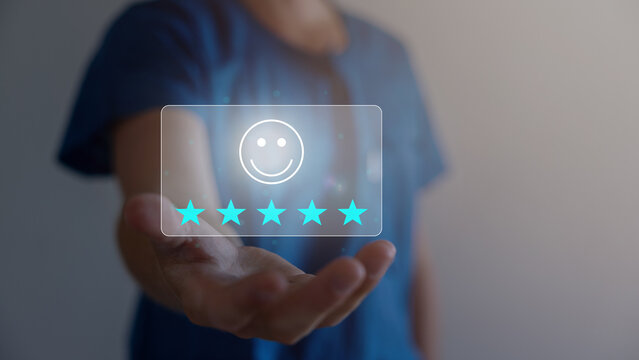 Technology customer assessment concept A close-up picture of a businessman showing satisfaction with the virtual technology with a smiley face and a five-star rating, business performance satisfaction