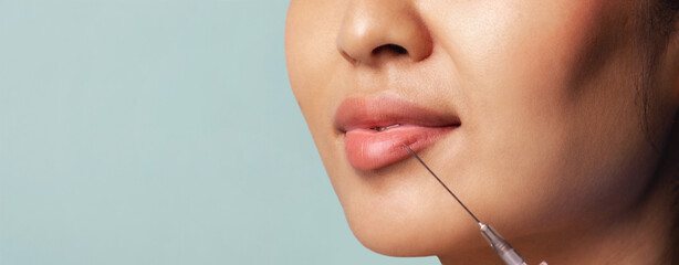 Young woman makes lip shape correction. Lip augmentation procedure. Beauty injection concept