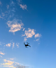 Blue sky and soft focus of a small drone flying. 