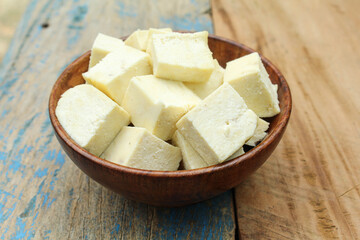 Paneer sliced in a wooden bowl 