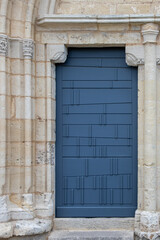 Fototapeta na wymiar old vintage door blue wooden grey exterior facade wall of european building