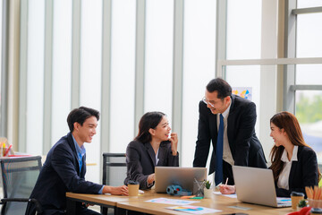 Professional Asian Colleagues in a Contemporary Office Setting, Strategizing for Corporate Growth and Efficiency
