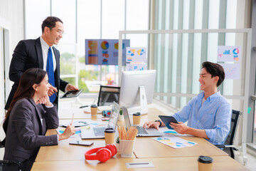 Professional Asian Colleagues in a Contemporary Office Setting, Strategizing for Corporate Growth and Efficiency