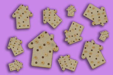decorative wooden houses on a lilac background. wooden toys. housing and construction concept