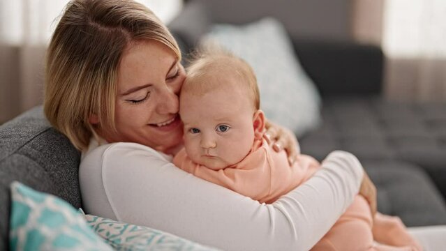 Mother And Daughter Hugging Each Other Kissing At Home