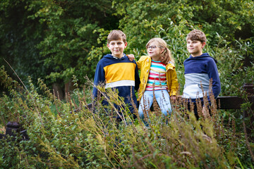 Portrait of three siblings children. Two kids brothers boys and little cute toddler sister girl...