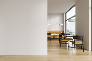 White restaurant interior with sofa and blank wall