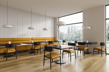 Stylish cafe interior with chairs and table in row, dining space with window
