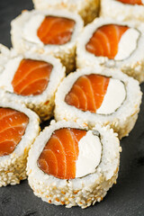 sushi roll with sesame salmon and Philadelphia cheese