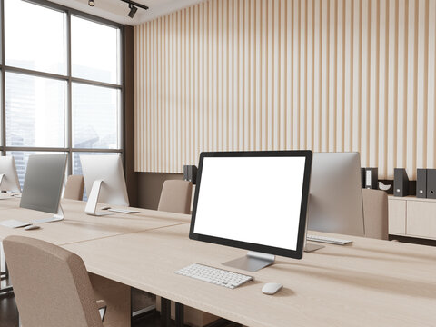 Blank computer screen in beige office