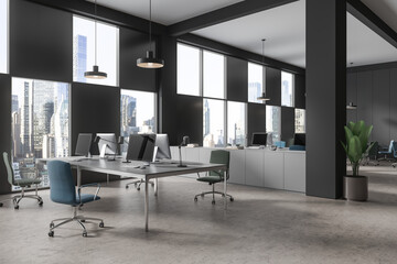 Modern coworking interior with pc monitors and sideboard with panoramic window