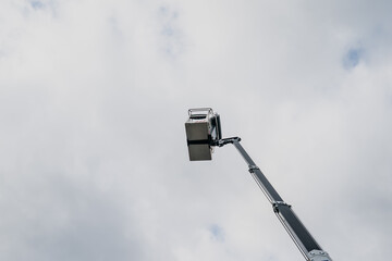 Construction lift basket elevated in the sky from below