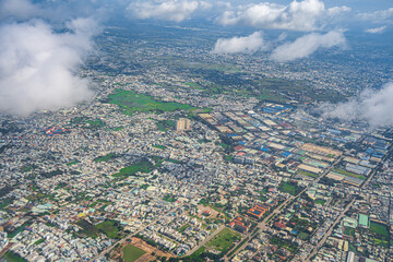 Looking from above the landscape of Ho Chi Minh City in Vietnam through the plane window when approaching the airport. Selective focus