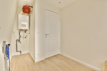 an empty room with white walls and wood flooring the door to the bathroom is in front of the wall