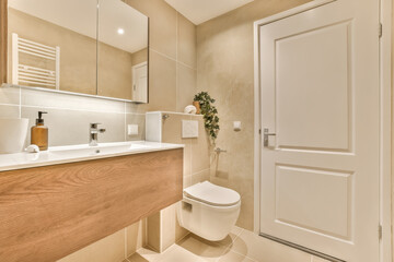Fototapeta na wymiar a modern bathroom with white fixtures and light wood cabinetd vanity, toilet and sink in the room is very clean