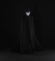 monster ghost in a black cloak on a black background