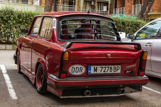 Red Trabant 601 on the parking lot in the city