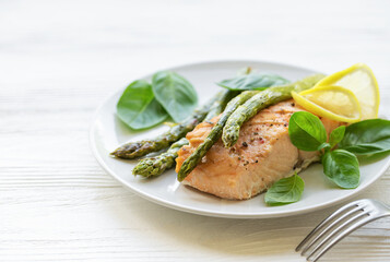 Baked Delicious salmon, green asparagus on  plate