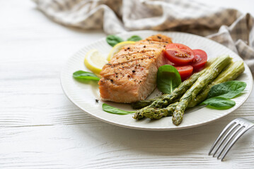 Baked Delicious salmon, green asparagus on  plate