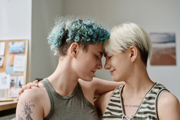 Lovely lesbian girls with eyes closed enjoying each other during their time at home