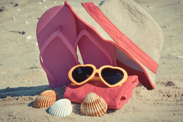 Accessories for relax on beach. Straw hat, flip flop, sunglasses and towel. Summertime