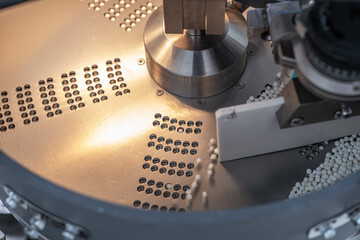 Macro Shot of colour Pills and Capsules During Production and Packing Process on Modern Pharmaceutical Factory. Tablet and Capsule Manufacturing Process. Close-up Shot of Medical Drug Production Line.