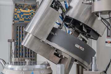 Macro Shot of colour Pills and Capsules During Production and Packing Process on Modern Pharmaceutical Factory. Tablet and Capsule Manufacturing Process. Close-up Shot of Medical Drug Production Line.