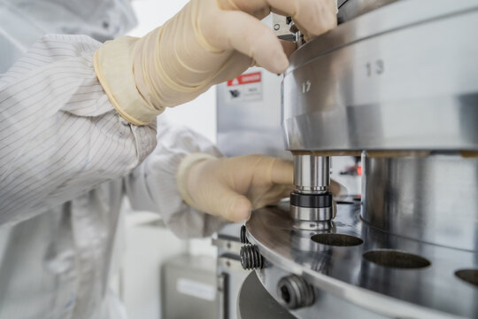 Closeup Punch-Tools Storage or outlet hopper of single punching tablet press machine for medicine industrial manufacture process.