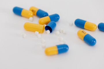 Macro Shot of colour Pills and Capsules During Production and Packing Process on Modern Pharmaceutical Factory. Tablet and Capsule Manufacturing Process. Close-up Shot of Medical Drug Production Line.