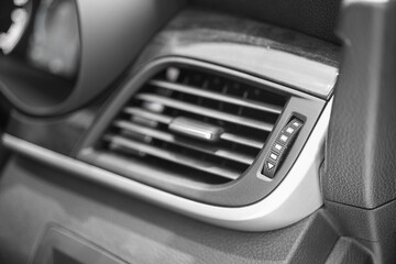 Air flow conditioning outlet channel and direction adjustment switch on the car interior dashboard. Vehicle tansportation part object, selective focus.