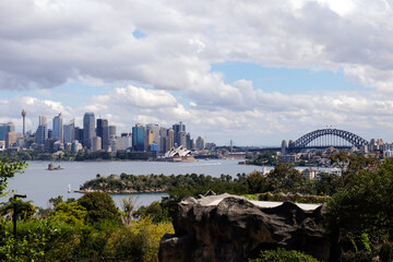 Naklejka premium Distant view of modern buildings and the opera house overlooking the Harbour in Sydney CBD, New South Wales, Australia