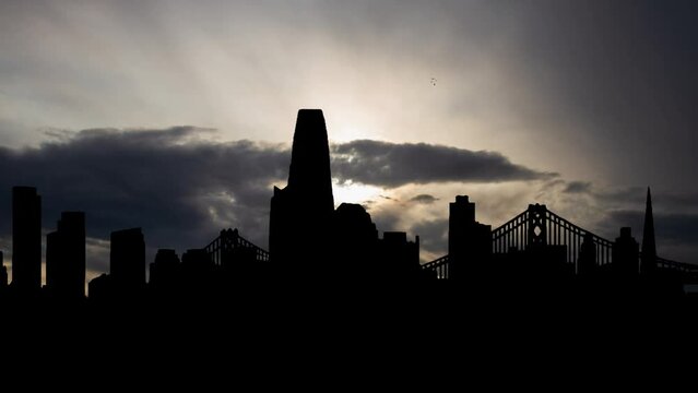 Skyline of San Francisco at Sunrise, Time Lapse  with Fast Clouds and Dark Silhouette of Metropolis, in California, USA