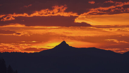 mountain silhouette with a beautiful orange sunset 