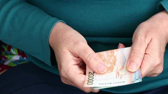 Chilean Pesos, Woman Counting Money, Cash Payments in Chile, Business and Finance, Home Budget, close up