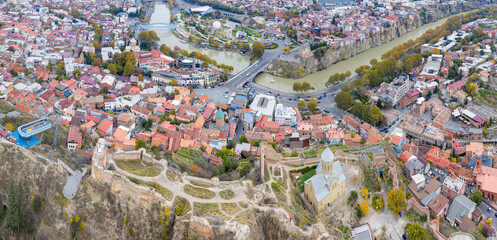 Panoramic aerial view of Old Town and Narikala Fortress on cloudy autumn day. Tbilisi, Georgia. © Kirill