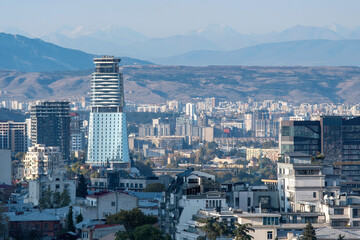 View of Tbilisi on the background of Caucasus Mountain Range on sunny autumn day. Georgia.