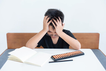 Asian child is worried. There is an intention to use the abacus in studying mathematics....