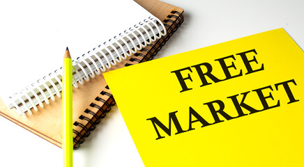 FRE MARKET text written on a yellow paper with notebook