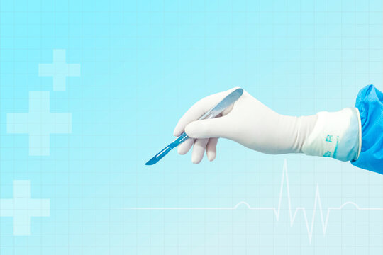 Doctor's hand holding a scalpel Background image of a doctor's hand holding a scalpel