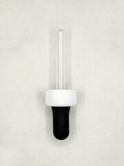 closeup shot of a plastic eye dropper pipette tool used for medical and scientific purposes isolated in a white background