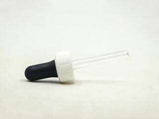 closeup shot of a plastic eye dropper pipette tool used for medical and scientific purposes isolated in a white background