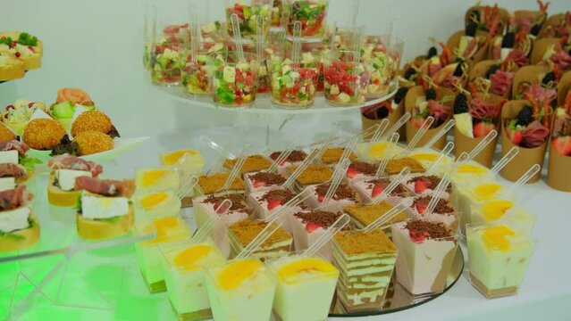 Candy bar, Sweets on stands. Delicious desserts at the banquet, sponge cakes, shortbread tarts. move camera shot