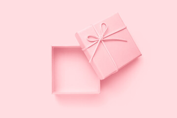 Open beige square gift box with a bow, top view