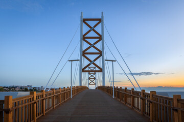 Fototapeta na wymiar Cycle-pedestrian bridge over the River Trancão, linking Lisbon to Loures, Portugal, at sunrise