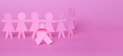 Pink Breast Cancer Awareness Ribbon. Pink paper ribbon bow with blur background of paper woman. October Pink day, a world cancer day.