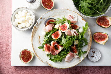 Arugula salad with figs and mozzarella cheese